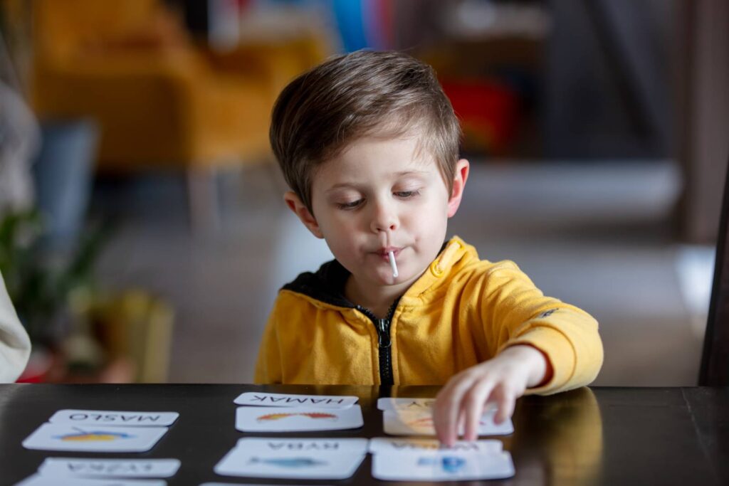 Young child working one-on-one with ABA therapist in center-based therapy room for autism